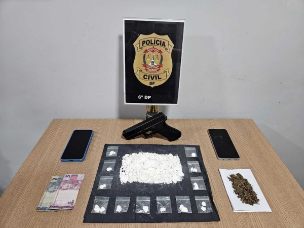 Imagem de uma mesa contendo o brasão da PCDF e as drogas (cocaína e maconha) apreendidas